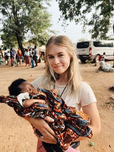 a woman holding a baby in her arms