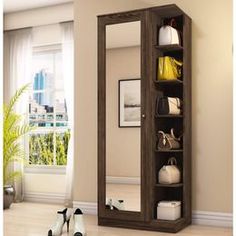 a large mirror sitting on top of a wooden shelf next to a wall mounted shoe rack