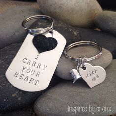 two keychains that say i carry your heart and one with a dog tag