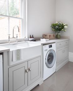 a washer and dryer in a white kitchen