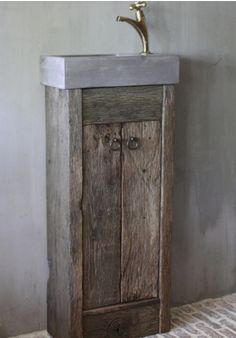 an old wooden cabinet with a metal faucet on the top is shown in this photo