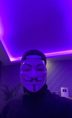 a person wearing a mask with purple lights in the background