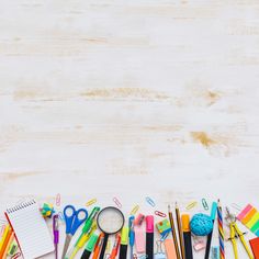 school supplies laid out on a white wooden surface