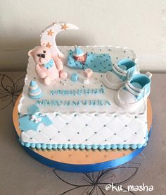 a baby shower cake is decorated with blue and white decorations, including a teddy bear