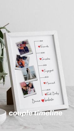 a couple's wedding pictures are displayed in a white frame on a table next to a potted plant