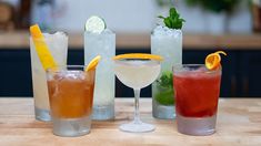 four different types of cocktails sitting on a table