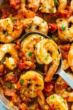 a skillet filled with shrimp and vegetables