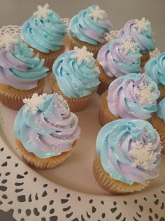 cupcakes with frosting and sprinkles are arranged on a plate