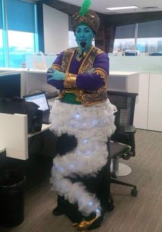 a man dressed in costume standing next to an office cubicle