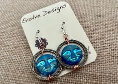 Beautiful recycled blue glass moon face celestial circle drop dangle earrings.  They measure 1.5 long Blue Round Earrings With Moon Charm, Blue Celestial Hypoallergenic Jewelry, Blue Celestial Round Earrings, Unique Moon Phase Round Earrings, Unique Round Moon Phase Earrings, Blue Celestial Nickel-free Earrings, Celestial Earrings, Moon Face, Drop Dangle Earrings