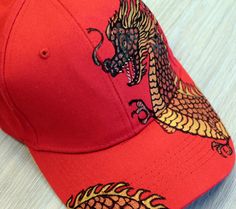 This summer baseball cap for women is hand-dyed with permanent fabric dye. 100% cotton baseball cap. The summer hat is adorned with a unique pattern of red dragonon . A baseball cap is a great addition to your summer wardrobe. Perfect as a gift for a girlfriend or mom. Has a one size fits all I need 7-10 days to draw a baseball cap. I will do it and send a photo of the finished cap. The design on the cap will not be an exact copy and may differ from the original. Dragon Hat, Unique Gifts For Girlfriend, Mama Hat, Dragon Rouge, Dragon Hats, Summer Baseball, Fantasy Baseball, Fabric Dye, Women Painting