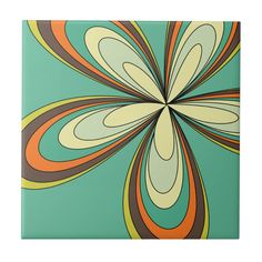 a square tile with an abstract flower design on it's center, in green and orange