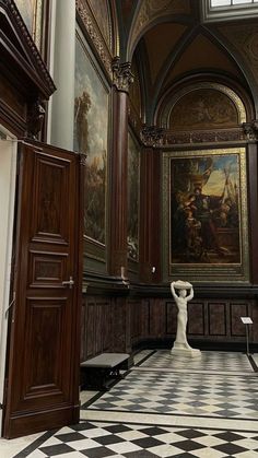 an ornate room with paintings on the walls and flooring, along with black and white checkered tile