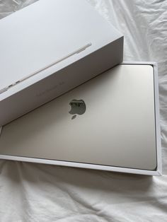 an apple box opened on top of a bed