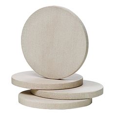 three circular concrete coasters stacked on top of each other in front of a white background