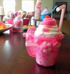 a pink cup sitting on top of a wooden table