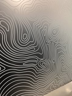 a wall with lines drawn on it next to a toilet