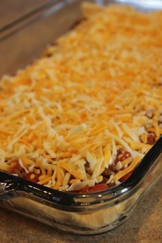 a casserole dish with cheese and meat in it sitting on a counter top