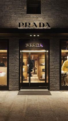 the prada storefront is lit up at night