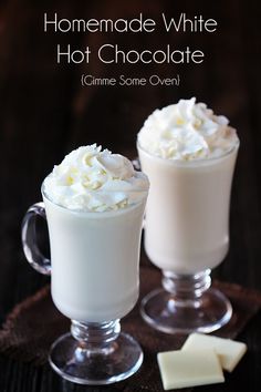 two glasses filled with whipped cream on top of a table