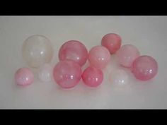 some pink and white balloons on a table