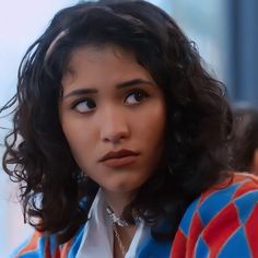 a close up of a person with curly hair