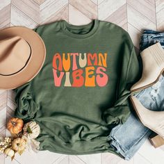 Looking for a cute versatile top to wear? Make sure to grab one of our Graphic Sweatshirts! This soft and comfortable shirt is the perfect top for any outfit. It can be paired with biker shorts, Jeans, or the classic stay at home sweats! This sweatshirt is true-to-size, so be sure to order your regular size! If you are looking for a more oversized look, make sure to size up. Cute Oversized Fall Tops, Cute Oversized Tops For Fall, Cozy Cotton Leisure Tops, Trendy Green T-shirt For Fall, Green Relaxed Fit Cozy Top, Green Cozy Relaxed Fit Top, Green Cozy Top With Relaxed Fit, Cozy Green Relaxed Fit Top, Cozy Graphic Print Tops For Fall