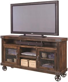 a flat screen tv sitting on top of a wooden entertainment center