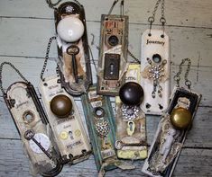 an assortment of old cell phones are displayed on a wooden table with chains and other items