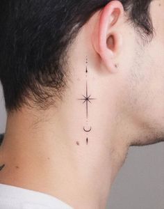 a man's neck with a small star and moon tattoo on his left side