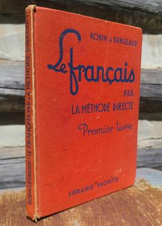 an old french book sitting on top of a piece of wooden planked furniture with the title le franois par la methode directe