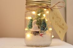 a jar filled with snow and christmas lights