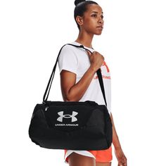 a woman carrying a black under armour gym bag