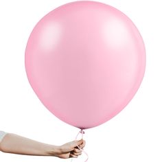 a person holding a pink balloon in their hand