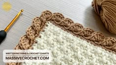 the crochet pattern is next to a ball of yarn and a knitting needle