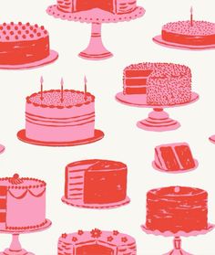 a bunch of different types of cakes on plates with candles in the middle one is pink and red