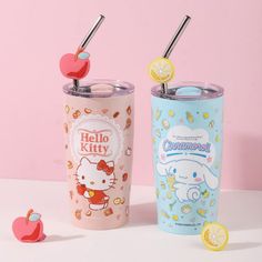 two hello kitty tumblers with straws and lemon slices on the side, one is pink