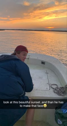 a man sitting in the bow of a boat on top of a body of water