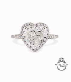 a heart shaped diamond ring with diamonds around it