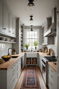 a kitchen with lots of counter space and white cabinets, along with a rug on the floor