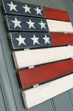 an american flag painted on the side of a building with white stars and red stripes