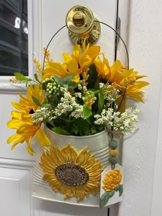 sunflowers and baby's breath in a white bucket hanging on the front door