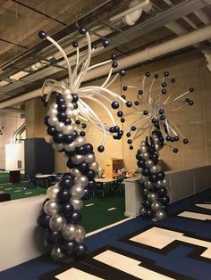 an office decorated with balloons and streamers in the shape of flowers, vines and leaves