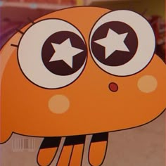 an orange cartoon character with stars on its eyes