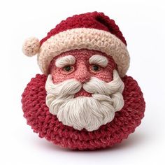 a crocheted santa claus ornament on a white background