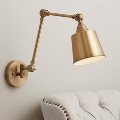 an image of a wall light that is on the side of a couch in a living room