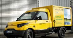 a yellow truck parked in front of a building