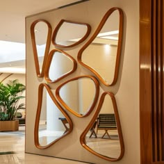 a large mirror mounted to the side of a wall next to a wooden planter