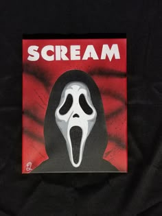 a scream sticker on a black shirt with the word scream printed on it's face