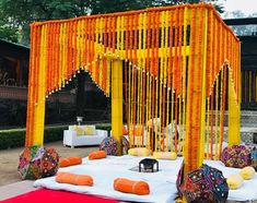 an outdoor ceremony with orange and yellow decorations